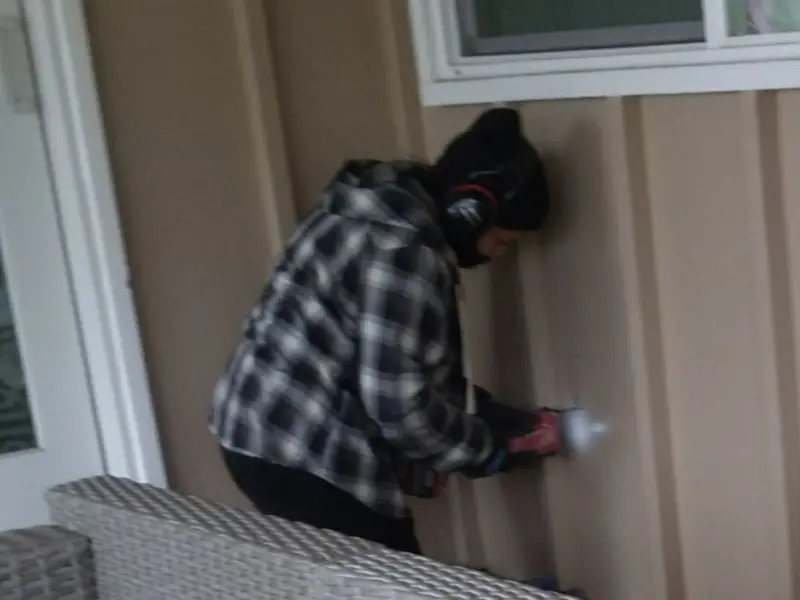 Professional electrician installing an exterior outlet in Robbins