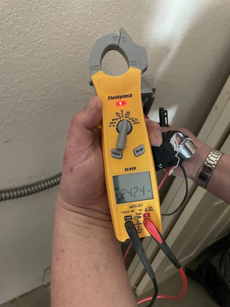 Voltage testing with clamp meter during Outlet Installation in Robbins